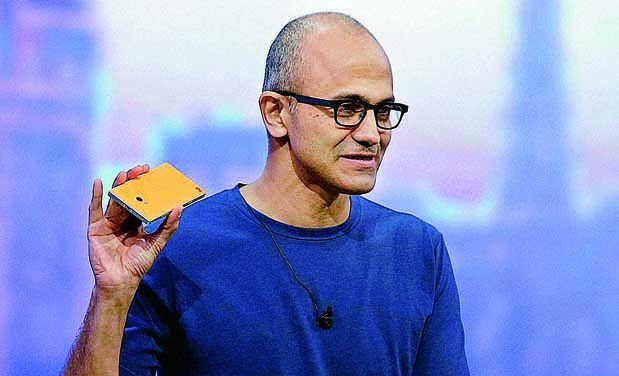 Microsoft CEO Satya Nadella holding a Nokia phone